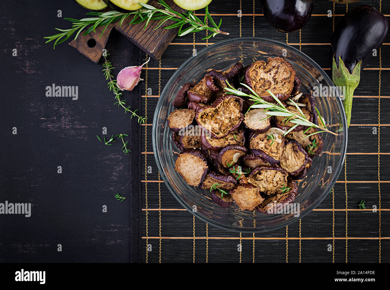 Italian sun-dried eggplant on a dark table. Preserved food. Italian appetizer. Top view Stock Photo