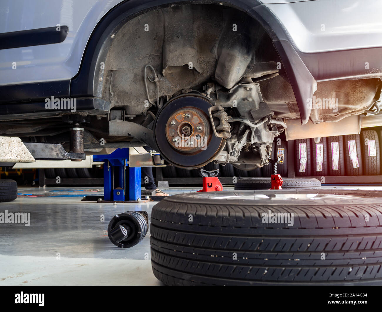Wheel car waiting for change tires on lifted automobiles at auto
