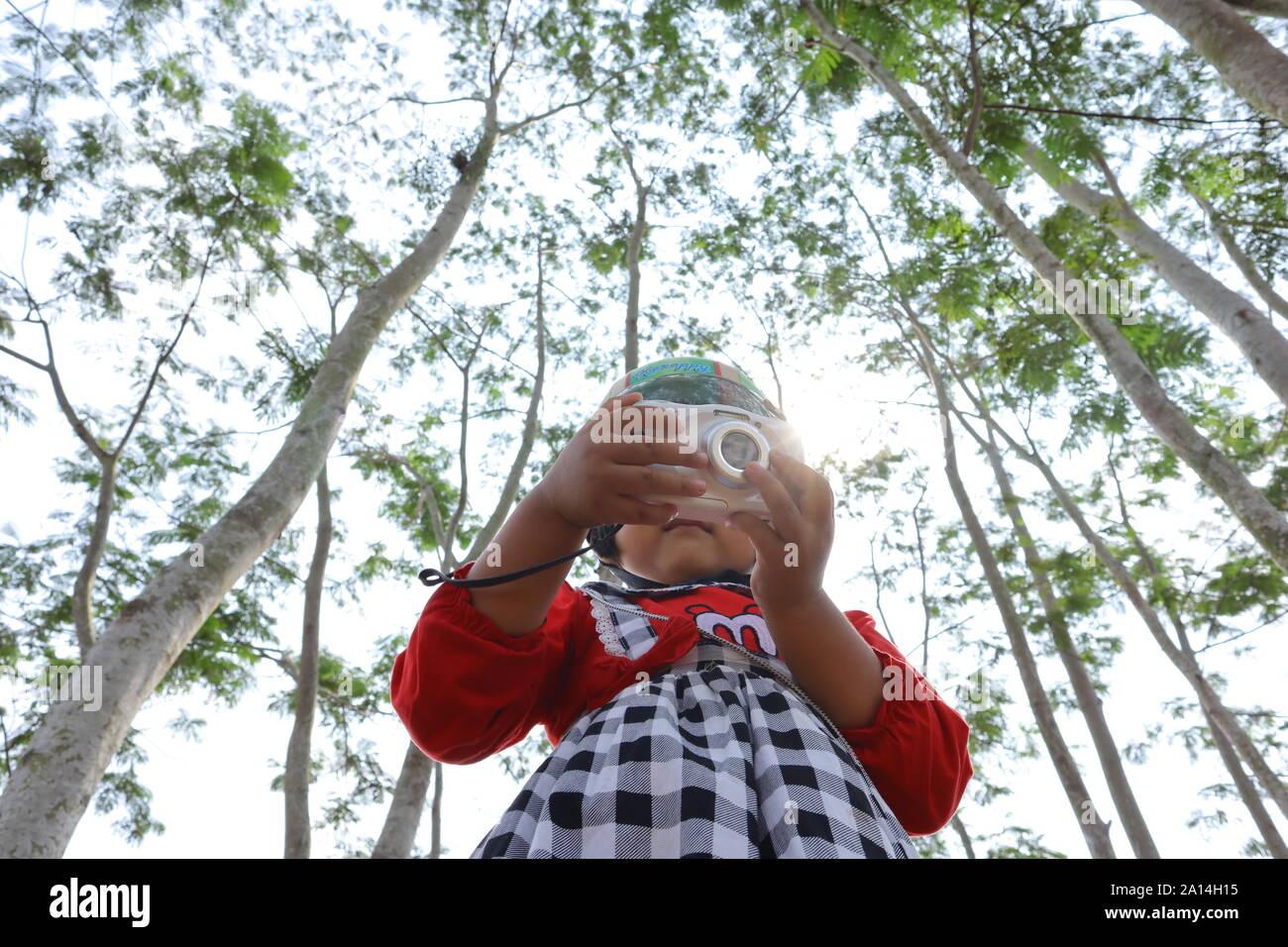 a photo of a child with a camera, technology is getting easier for allli Stock Photo