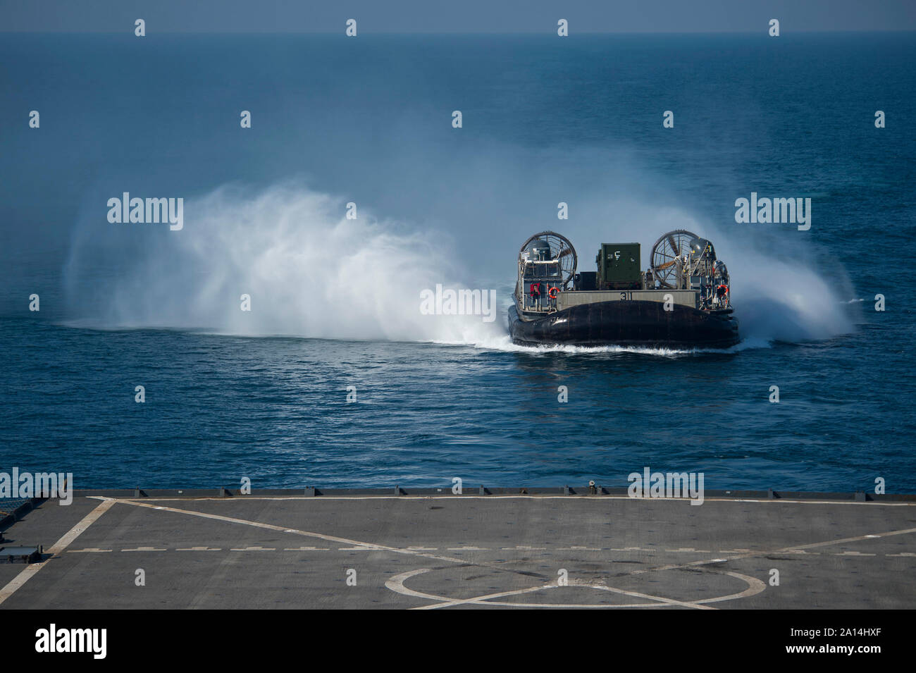 A Landing Craft Air Cushion makes its approach to the well deck of USS Comstock. Stock Photo