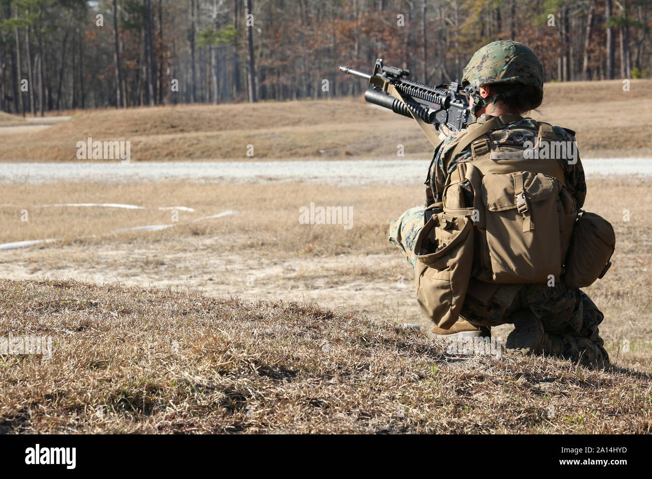A U.S. Marine fires an M203 grenade launcher. Stock Photo