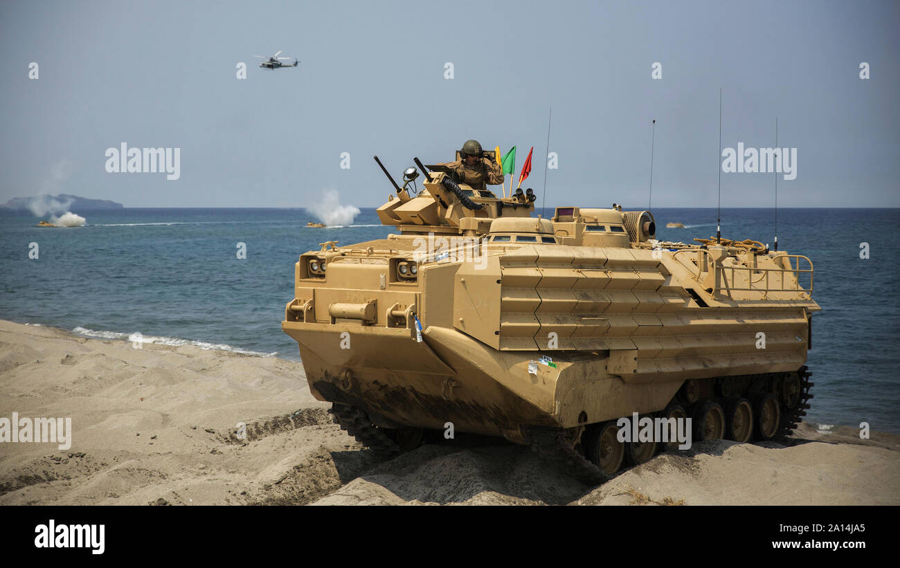 A crewman communicates with other AAVs after landing ashore. Stock Photo