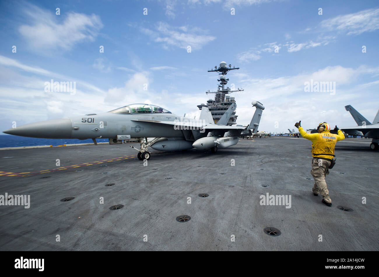 Chief Aviation Boatswain's Mate directs an EA-18G Growler aboard USS George Washington. Stock Photo