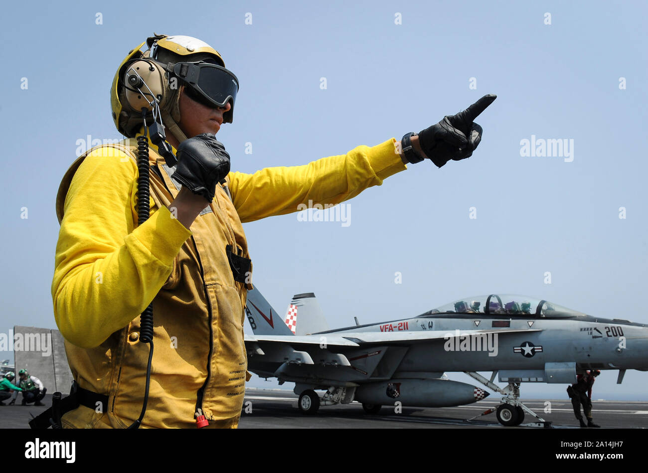 Aviation Boatswain's Mate prepares an F/A-18F Super Hornet for launch. Stock Photo