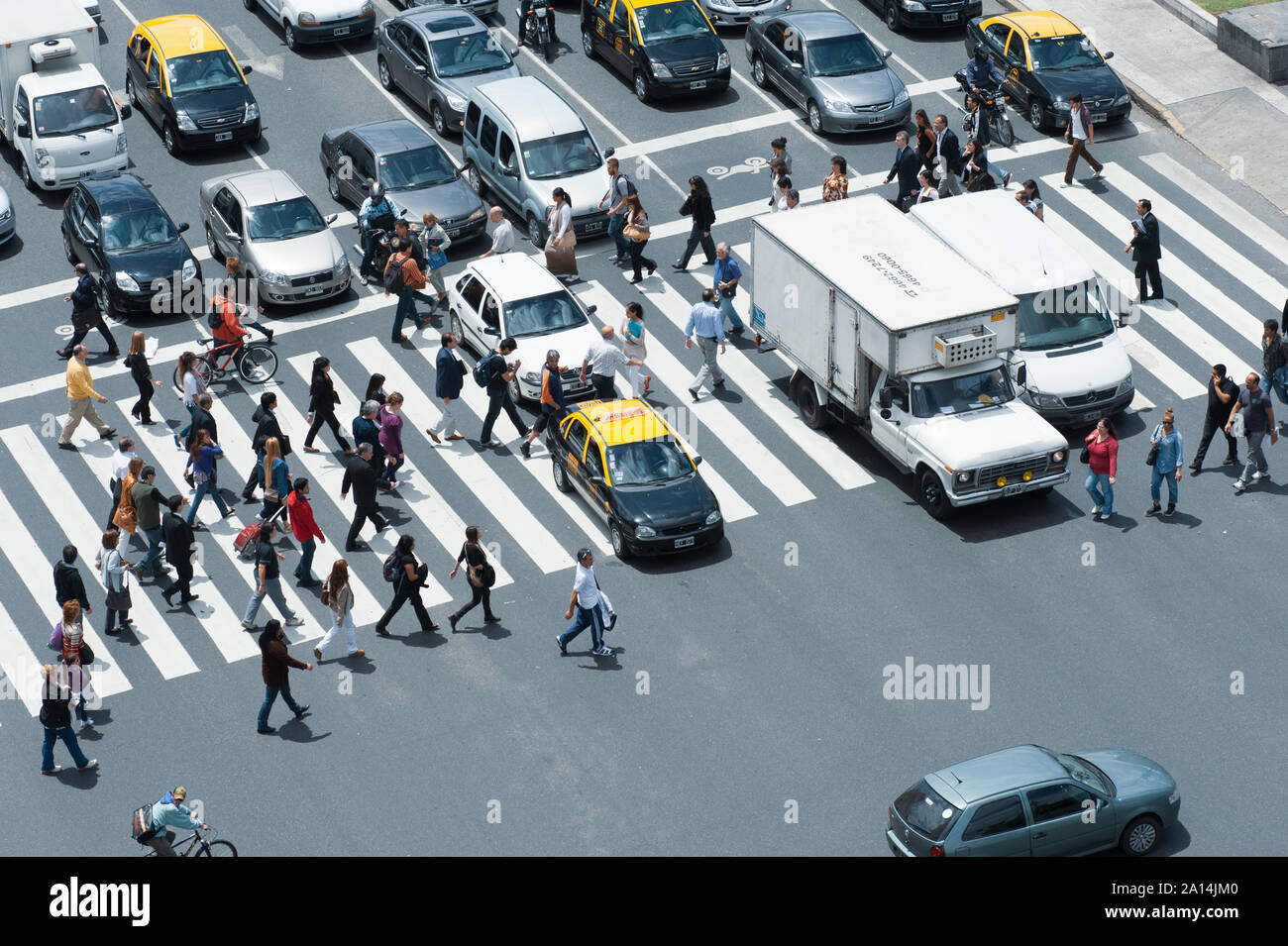 Buenos Aires, Argentina - November 12 2012: Pedestrians crossing the street over the zebra. Stock Photo