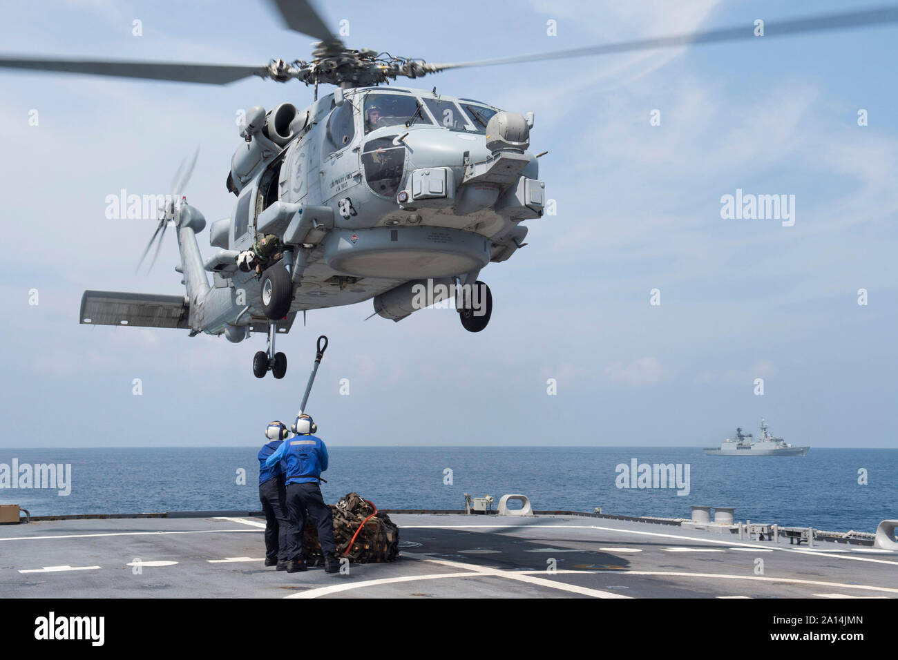 U.S. Sailors attach a sling load during a vertical replenishment. Stock Photo