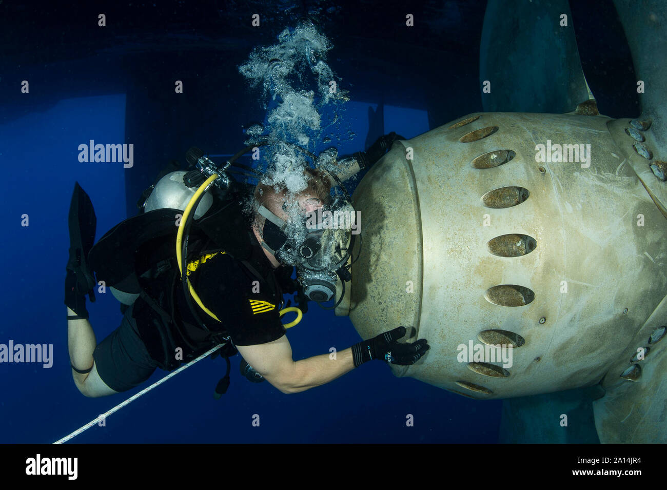 U.S. Navy Diver conducts a ship's husbandry dive to inspect running gear. . Stock Photo