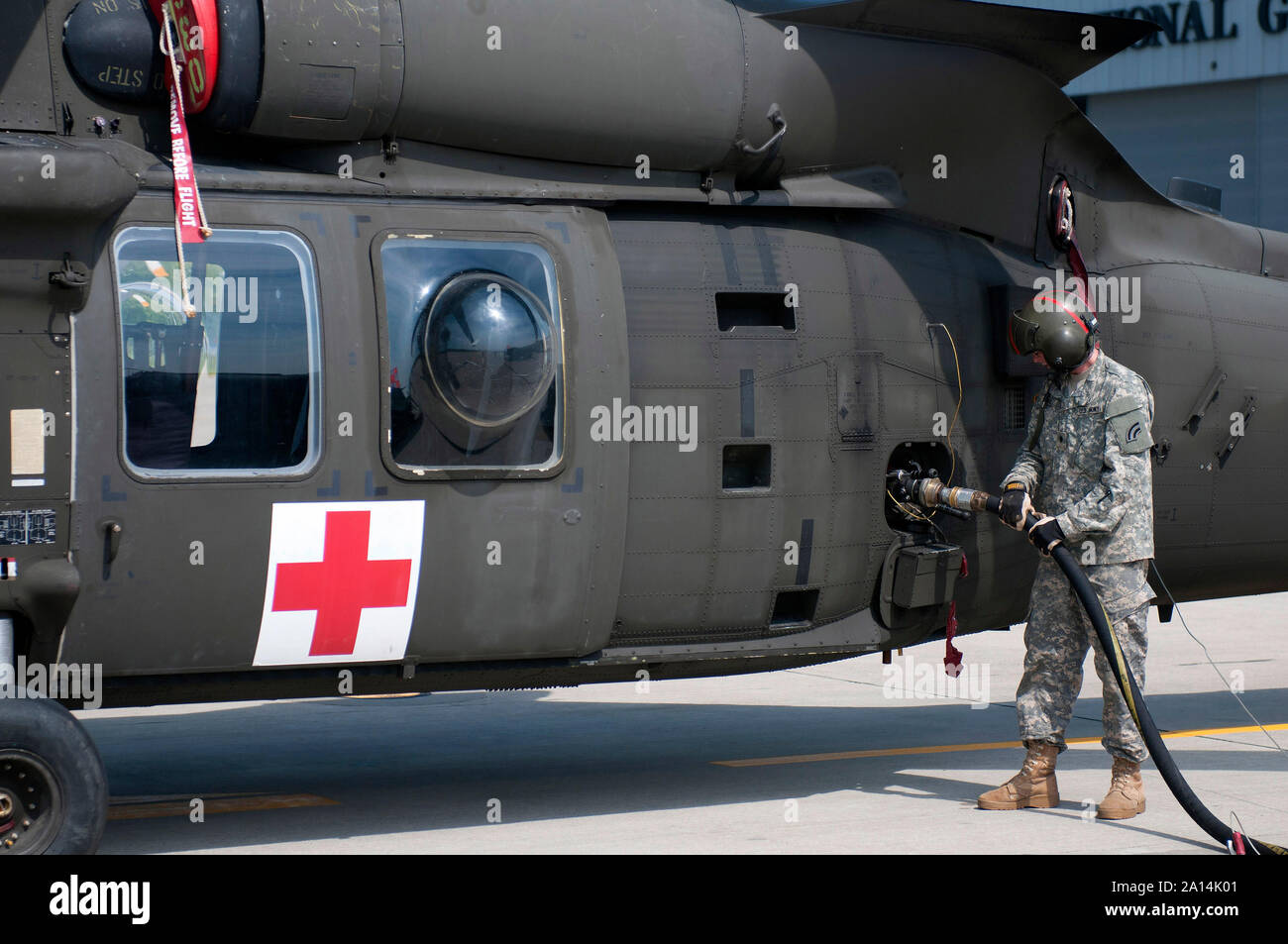 Petroleum supply specialist refuels a UH-60 Black Hawk helicopter. Stock Photo