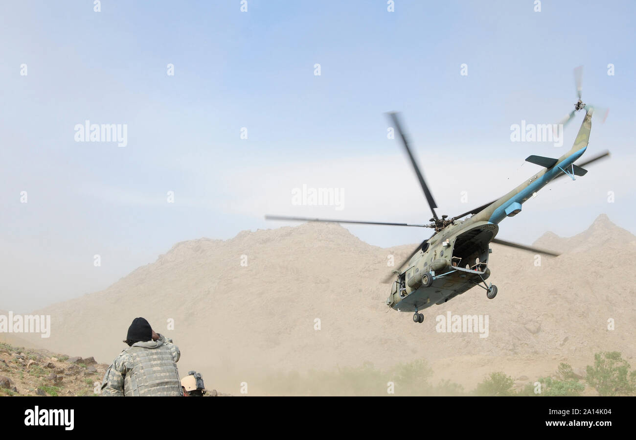 A Mi-17 Hip helicopter takes flight after dropping off Afghan National Army commandos Stock Photo