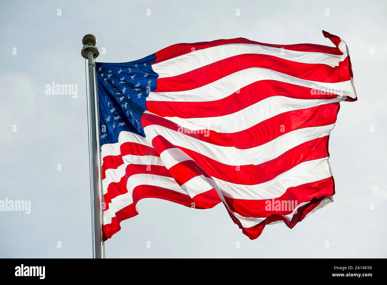 The American flag waves in the wind. Stock Photo