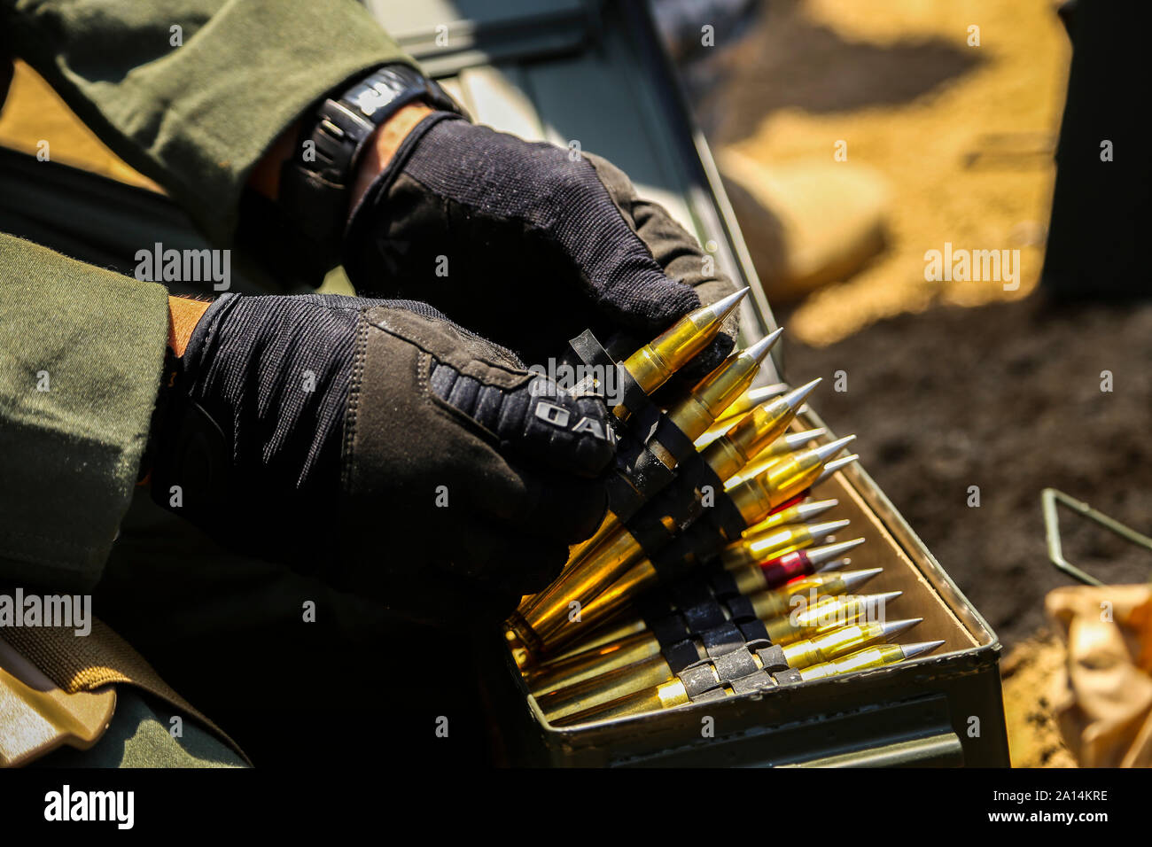 A Marine Explosive Ordnance Disposal technician prepares to stage .50 Caliber rounds. Stock Photo