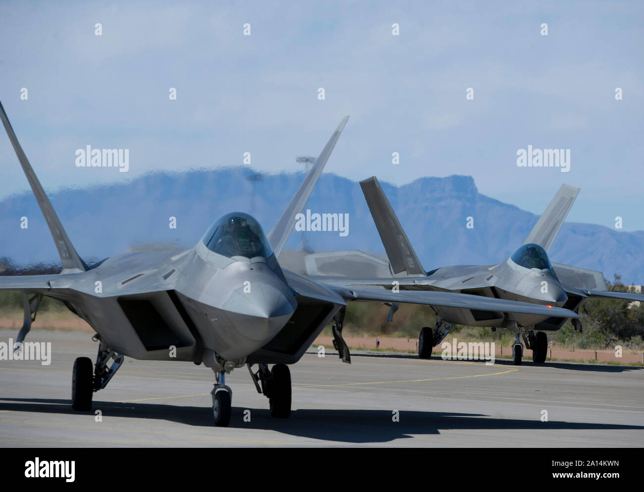 A pair of F-22 Raptors taxiing on the runway. Stock Photo