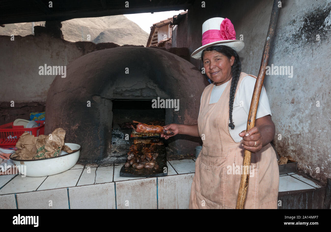 Cuzco, Peru - August 13 2011: A peruvian cook and the oven. Showing a roasted cuis. Stock Photo