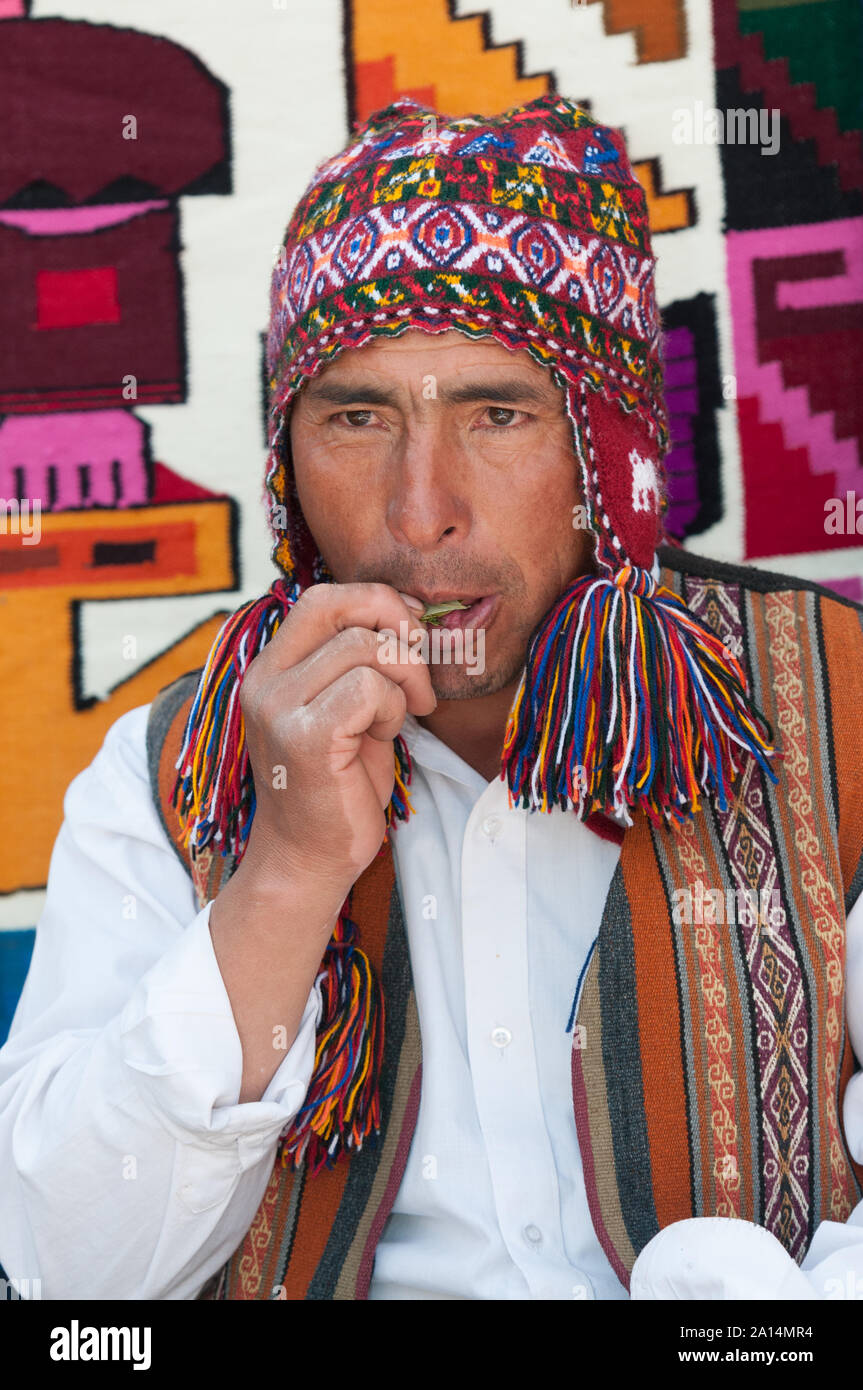 Chincheros, Peru - July 31 2011: A man wearing typical clothes, eating leaves of coca. Stock Photo