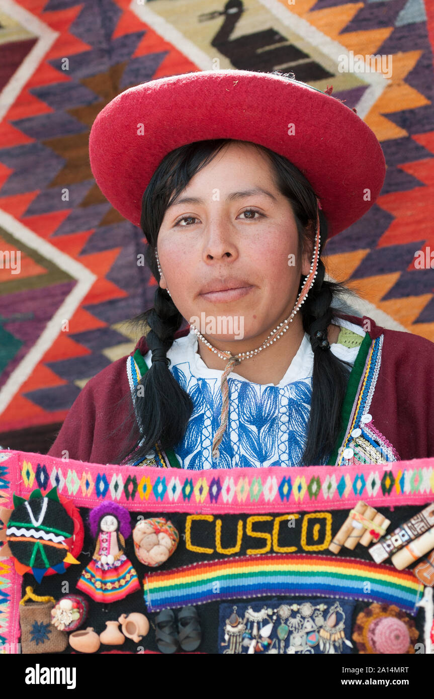 Chincheros, Peru - July 31 2011: A girl wearing typical clothes, selling tapestry. Stock Photo