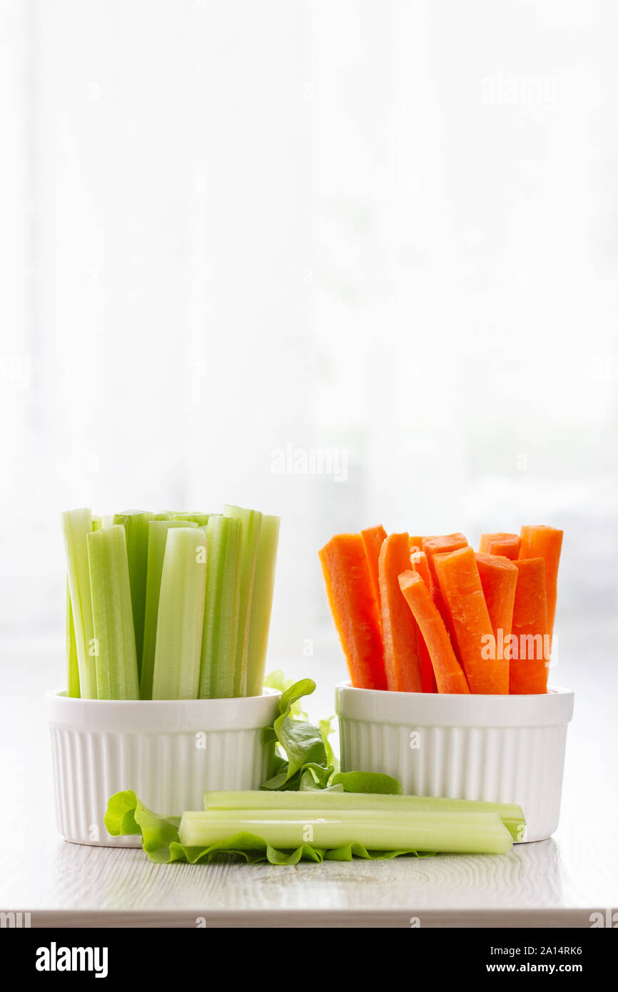 Vegetarian healthy food concept. Green celery, lettuce leaves and carrot Stock Photo Alamy