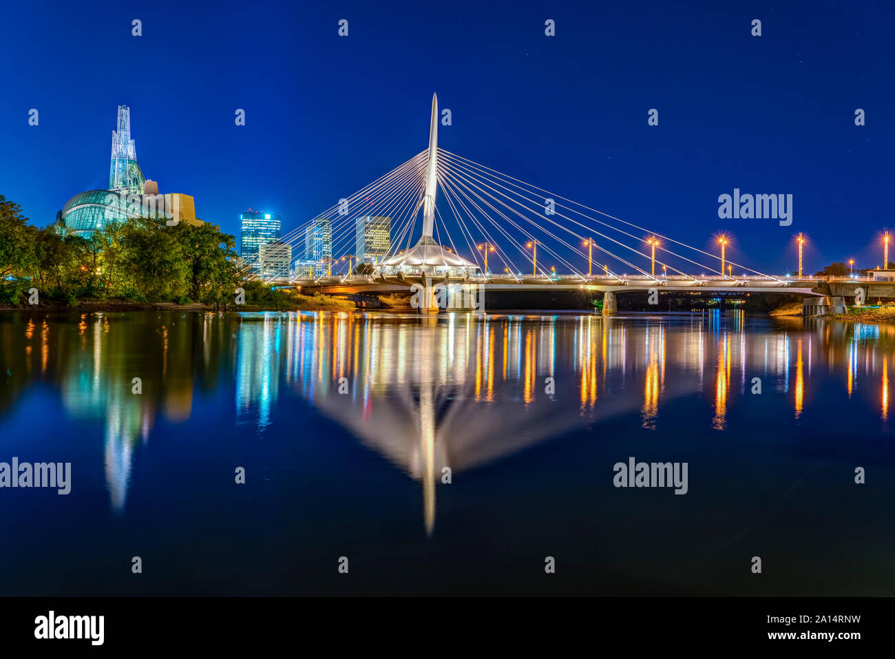 The city skyline from the St. Boniface Promenade at night in Winnipeg