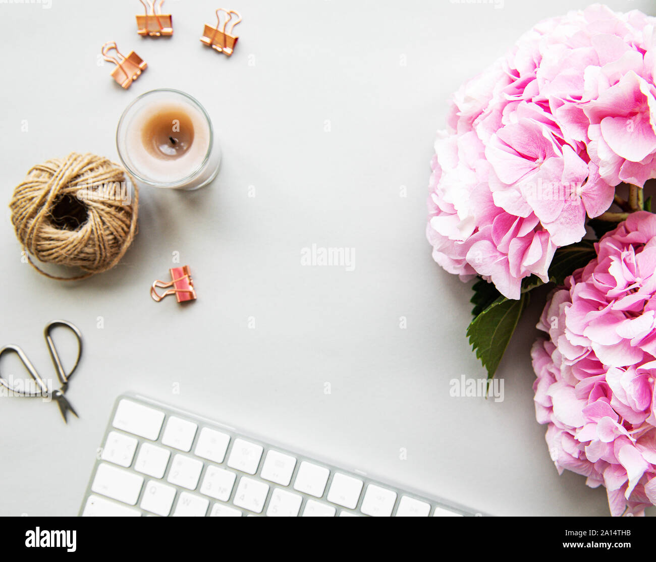 Home Office Desk Workspace With Pink Hydrangea Flowers Bouquet On