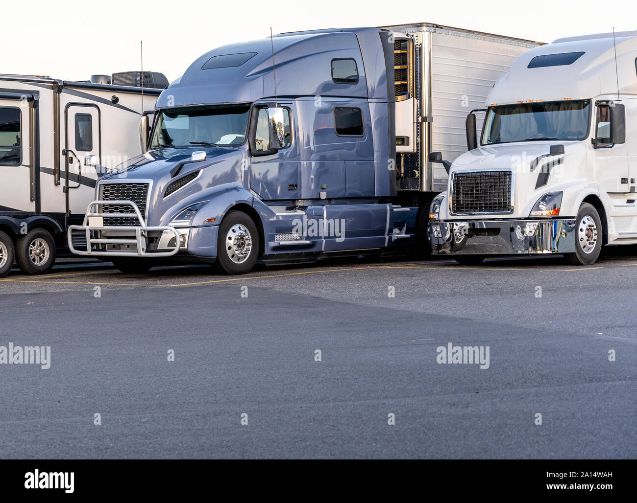 Different make and models big rigs semi trucks with semi trailers