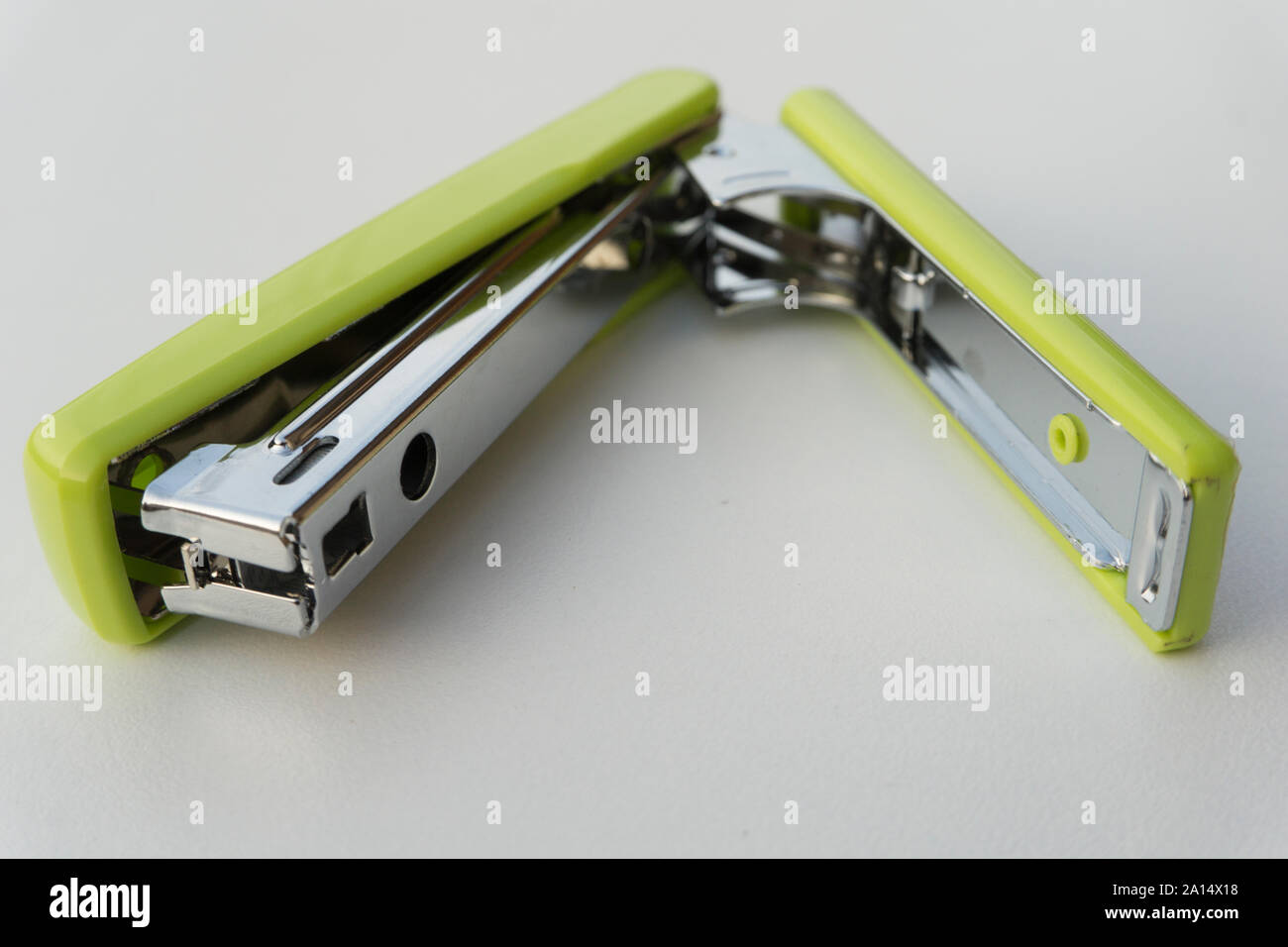Green stapler isolated on white background. Stock Photo