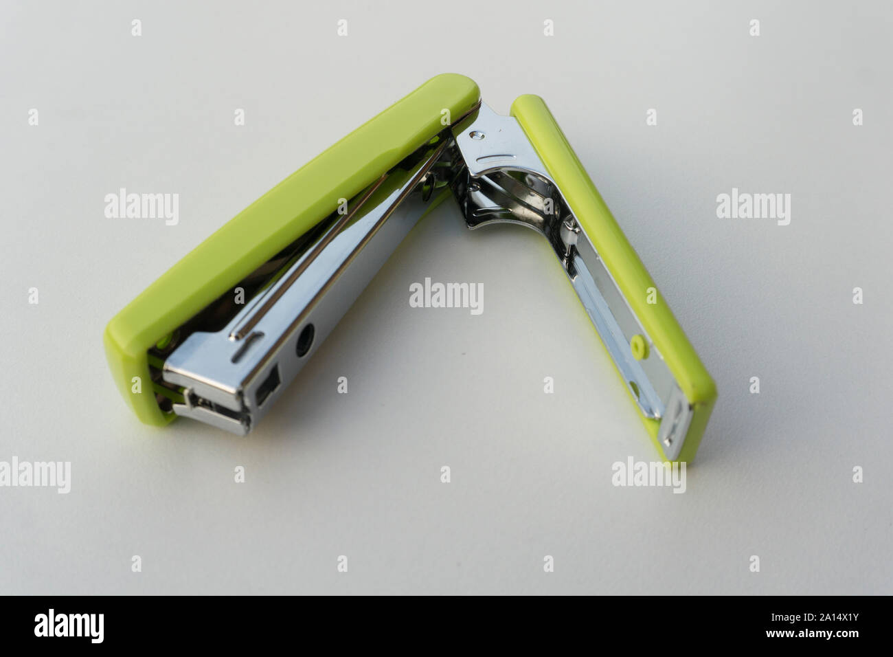 Green stapler isolated on white background. Stock Photo