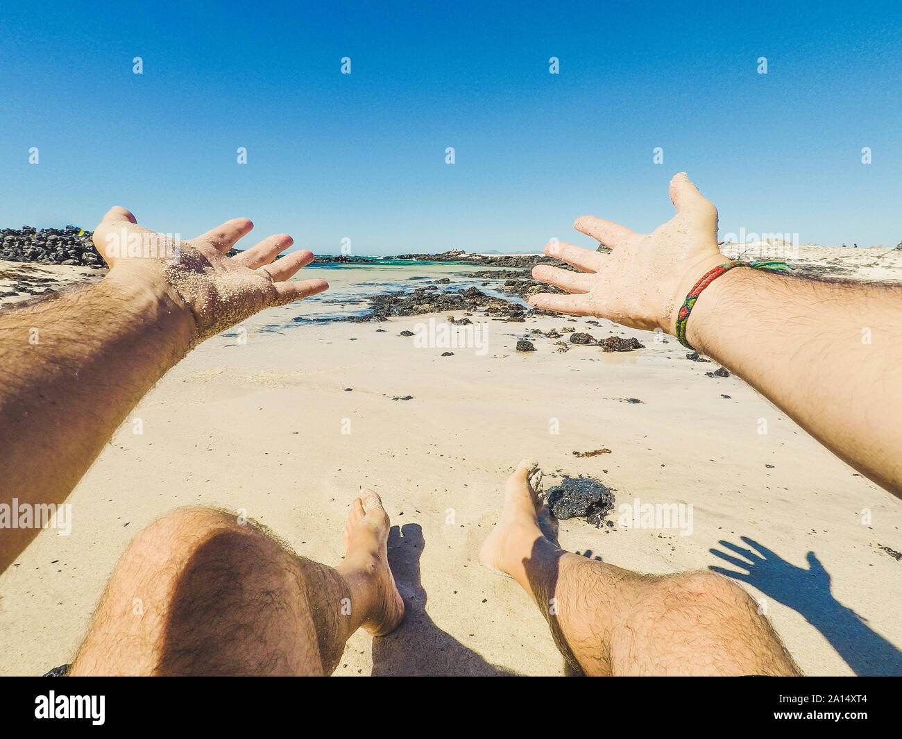 Summer holiday vacation and happiness concept with men eyes point of view of beautiful sandy beach and blue ocean water - happy people in outdoor leis Stock Photo