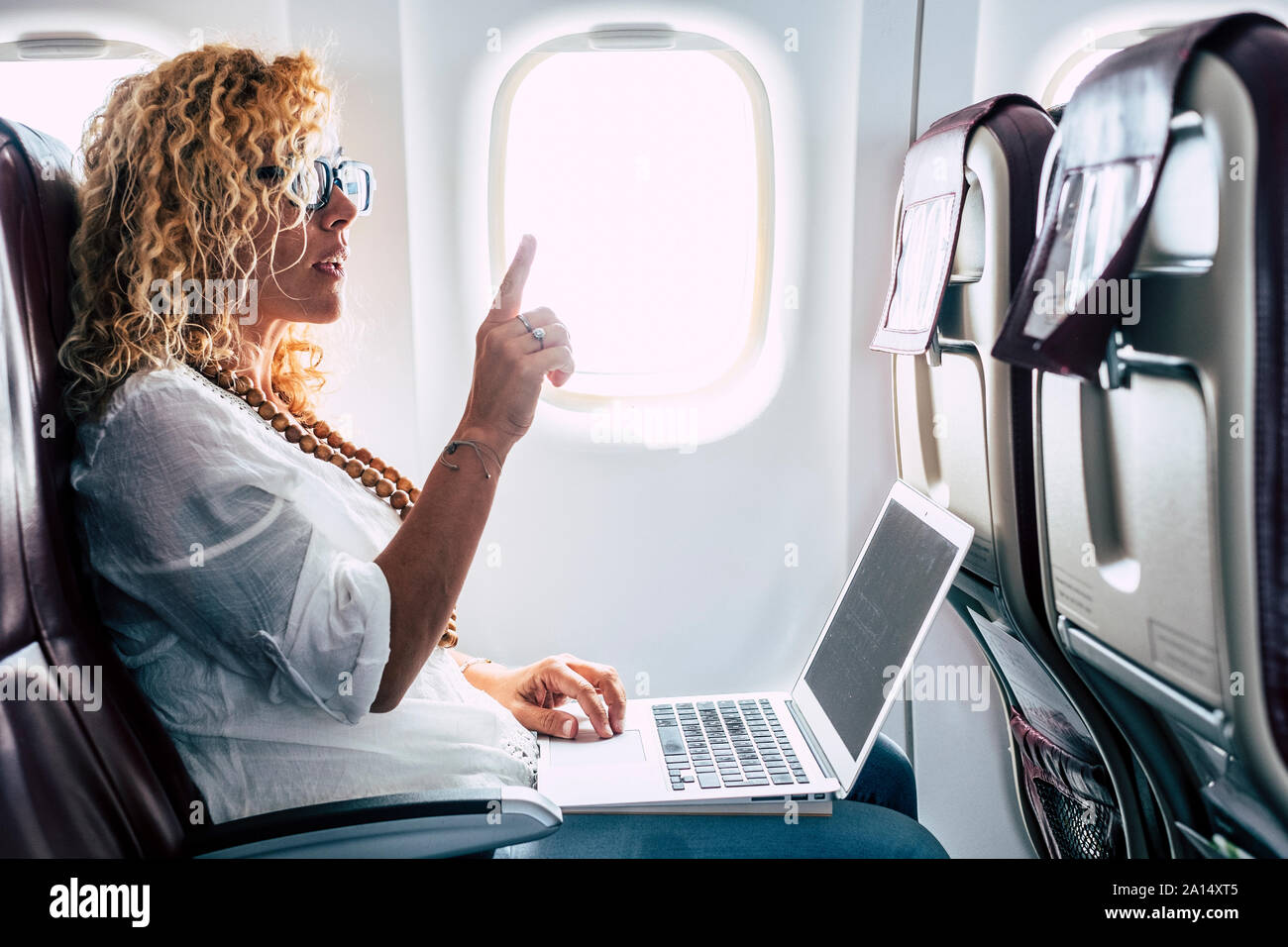 Young business woman with laptop airplane hi-res stock photography and ...