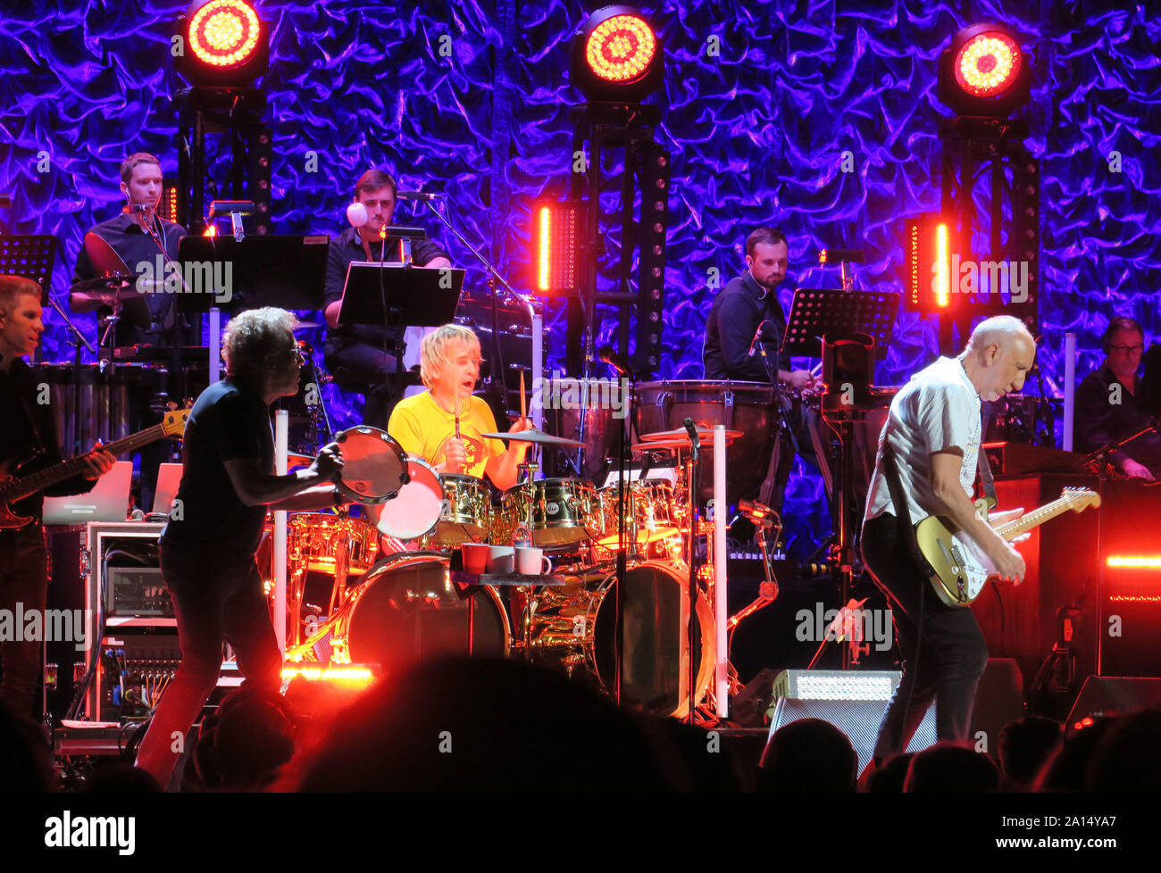 Tampa, United States. 22nd Sep, 2019. September 22, 2019 - Tampa, Florida, United States - Roger Daltrey (second left with tambourine), Zak Starkey (on drums) and Pete Townshend (right on guitar) of the English rock band The Who perform with members of a 48-piece orchestra at the Amalie Arena on the second leg of their Moving On! tour on September 22, 2019 in Tampa, Florida. Credit: Paul Hennessy/Alamy Live News Stock Photo