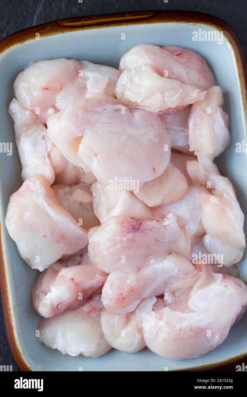 Raw, uncooked ray cheeks prior to cooking. Ray cheeks were sometimes referred to as skate knobs and were once a common sight in fishmongers in the UK, Stock Photo