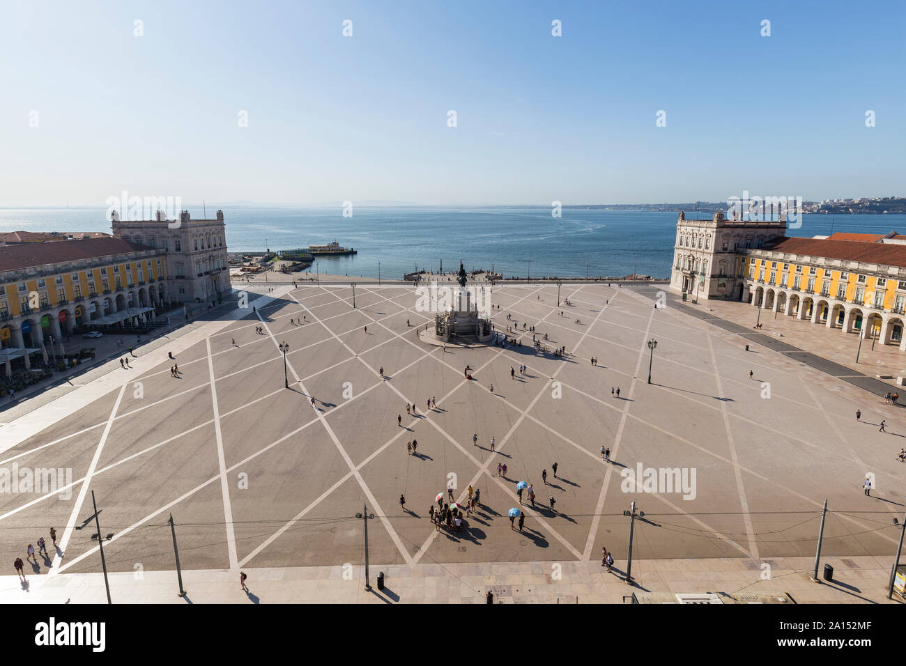View of Tagus River and people and statue of King Jose I at Praca do Comercio square in Baixa district in Lisbon, Portugal, from above on a sunny day. Stock Photo
