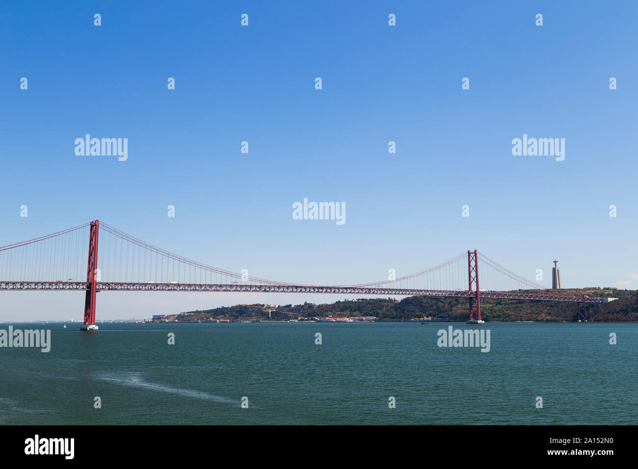 Tagus River, 25 de Abril Bridge (25th of April Bridge) and Sanctuary of Christ the King (Santuario de Cristo Rei) monument in Lisbon, Portugal. Stock Photo