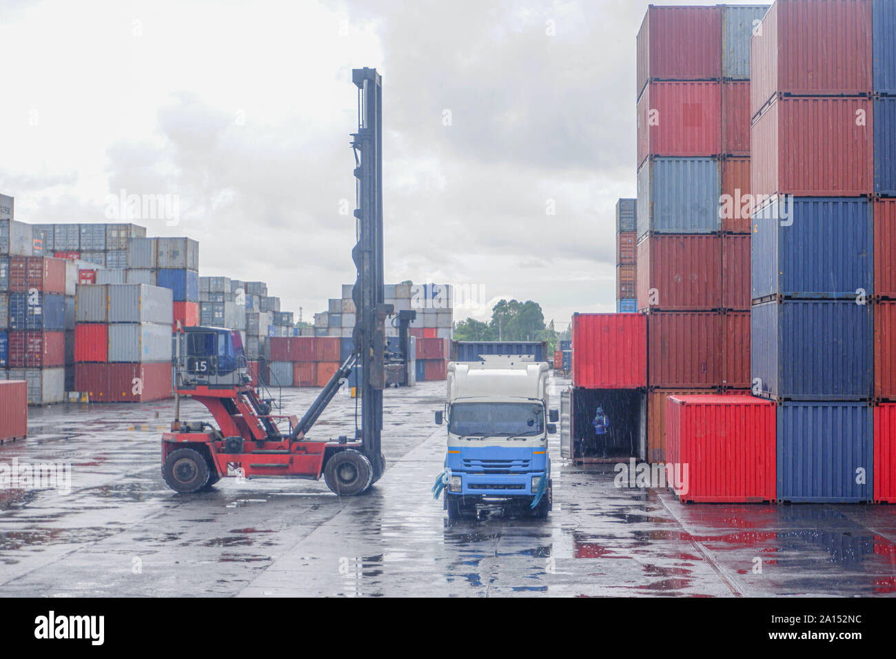 Container loading and unloading equipment works while it rains Stock ...