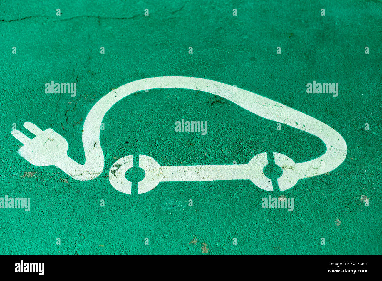 Electric charge station. Car charging symbol painted on asphalt. Ecology fuell concept. Stock Photo