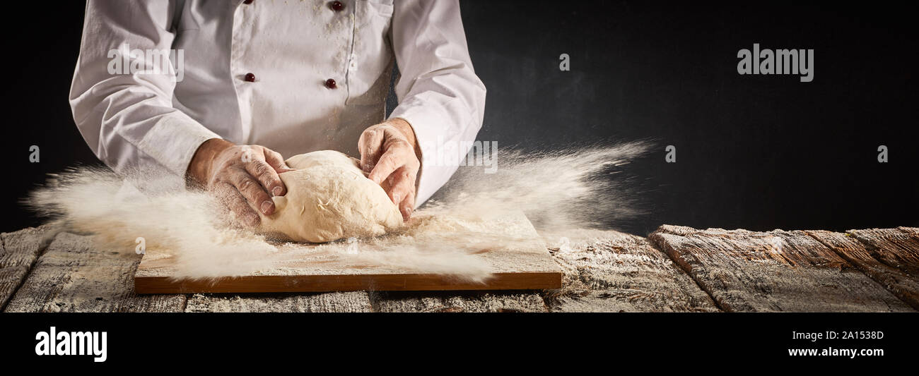 Explosion of flour suspended in the air in a pizzeria kitchen as the