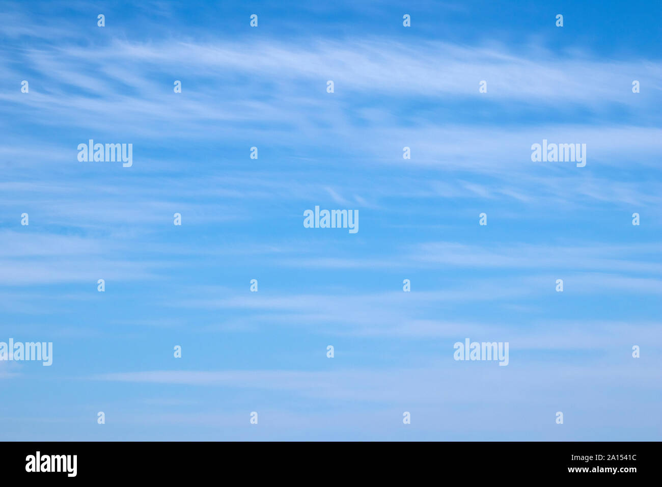 Wispy white clouds against a blue sky Stock Photo