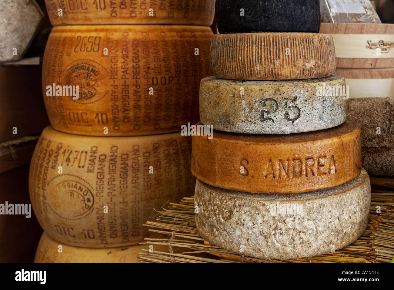 Different types of artisan smoked hard cheese and Parmesan wheels on the stall during traditional International Cheese festival. Stock Photo