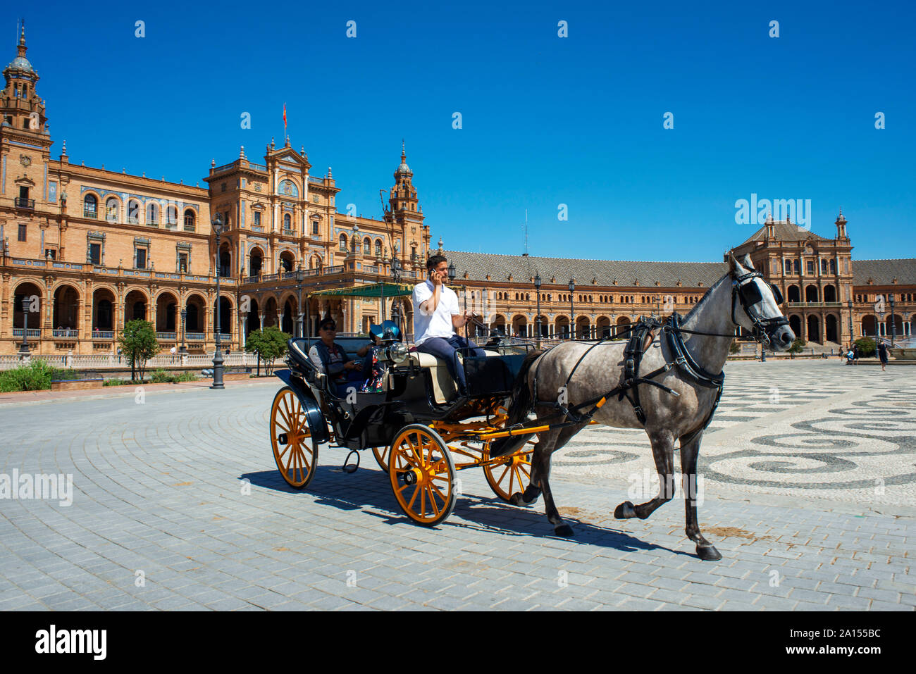 Horse drawn carriages in Plaza de Espana Seville, Sevilla on a summer