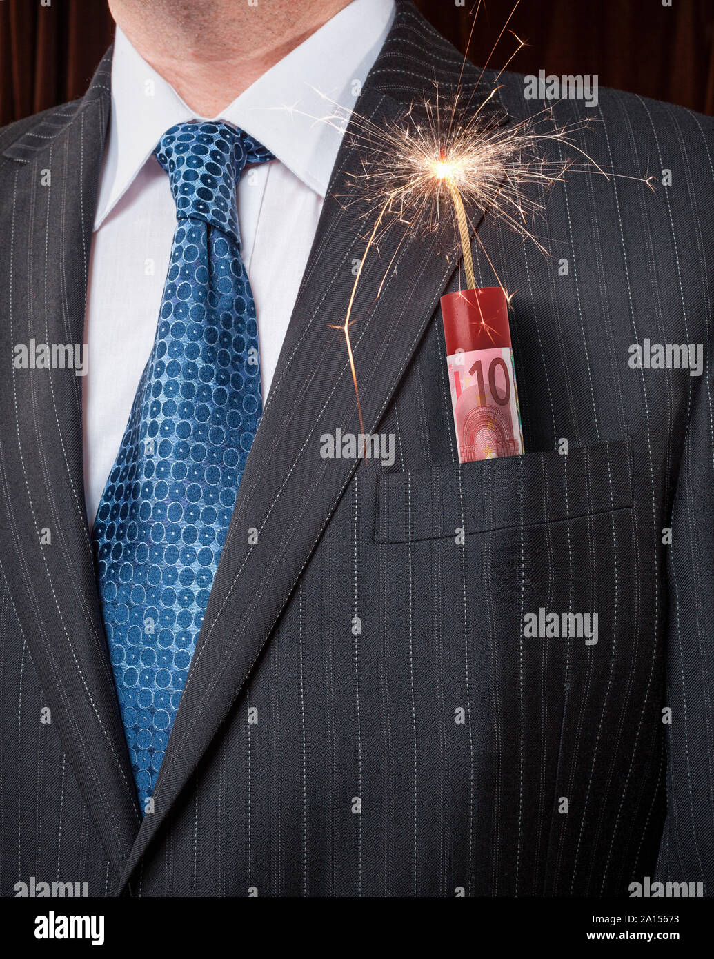 Businessman with Euro currency banknote wrapped around explosives dynamite Stock Photo