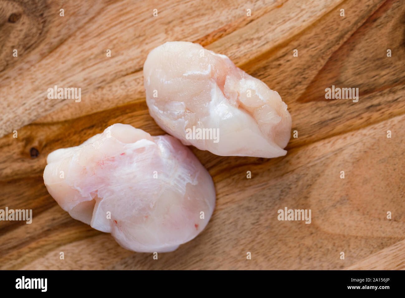 Two raw, uncooked ray cheeks prior to cooking. Ray cheeks were sometimes referred to as skate knobs and were once a common sight in fishmongers in the Stock Photo