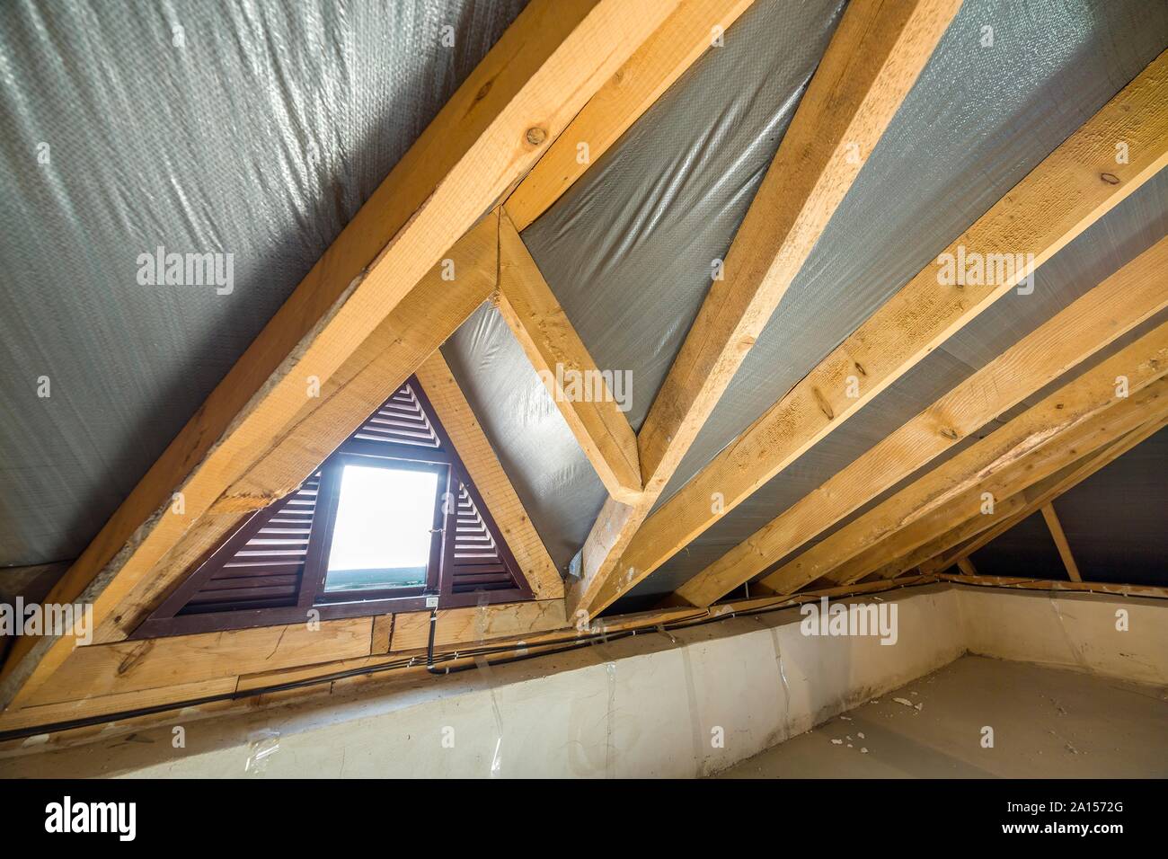 Attic Of A Building With Wooden Beams Of A Roof Structure And A