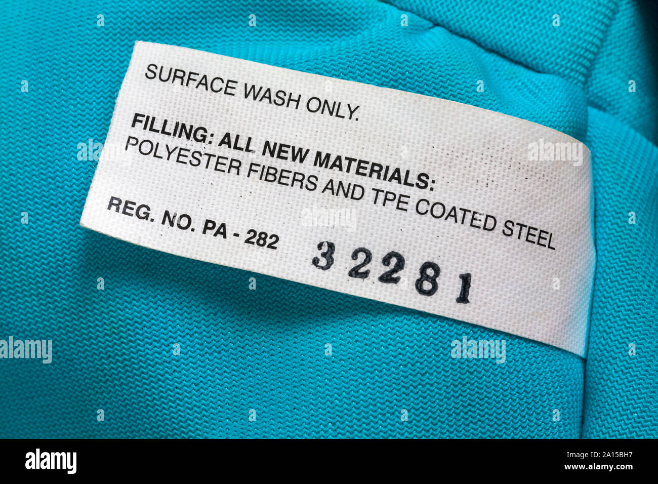 Surface wash only filling all new materials polyester fibers and tpe coated steel - label on soft toy Stock Photo