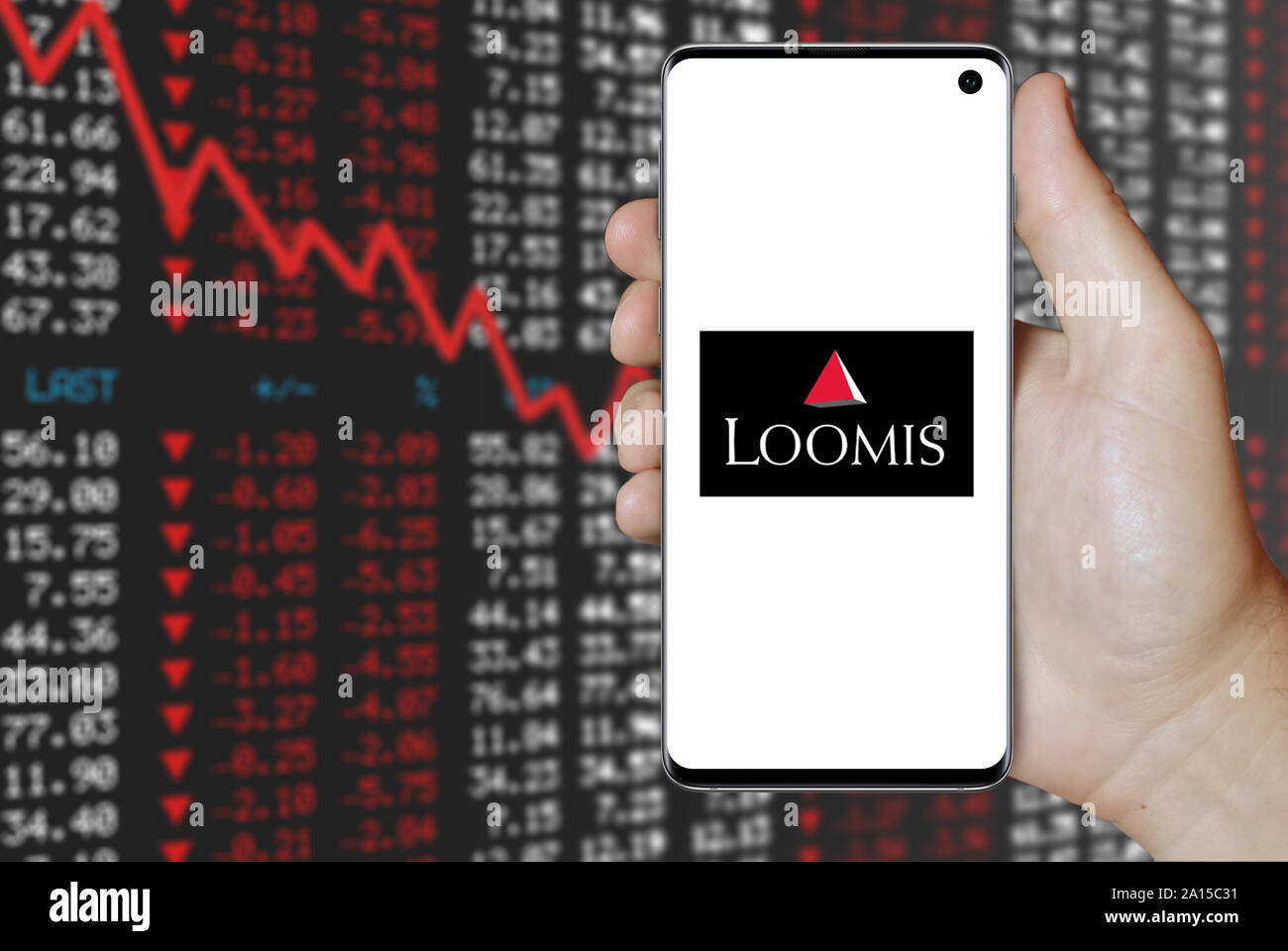 A man holds a smartphone displaying the logo of company Loomis listed on  OMX Stockholm. Negative stock market background. Credit: PIXDUCE Stock  Photo - Alamy