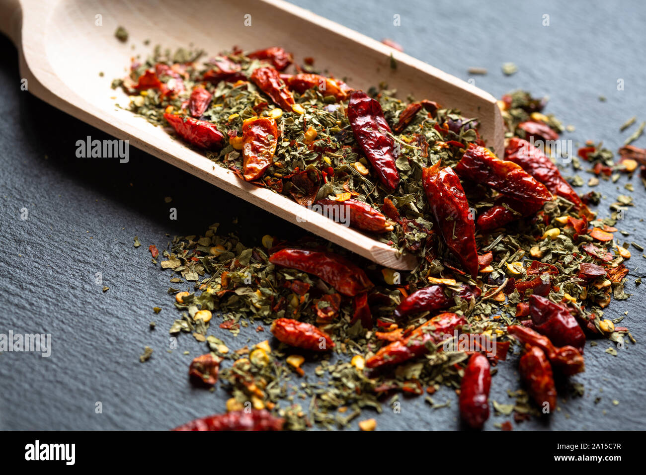 Dried oregano and chillies on wooden scoop Stock Photo