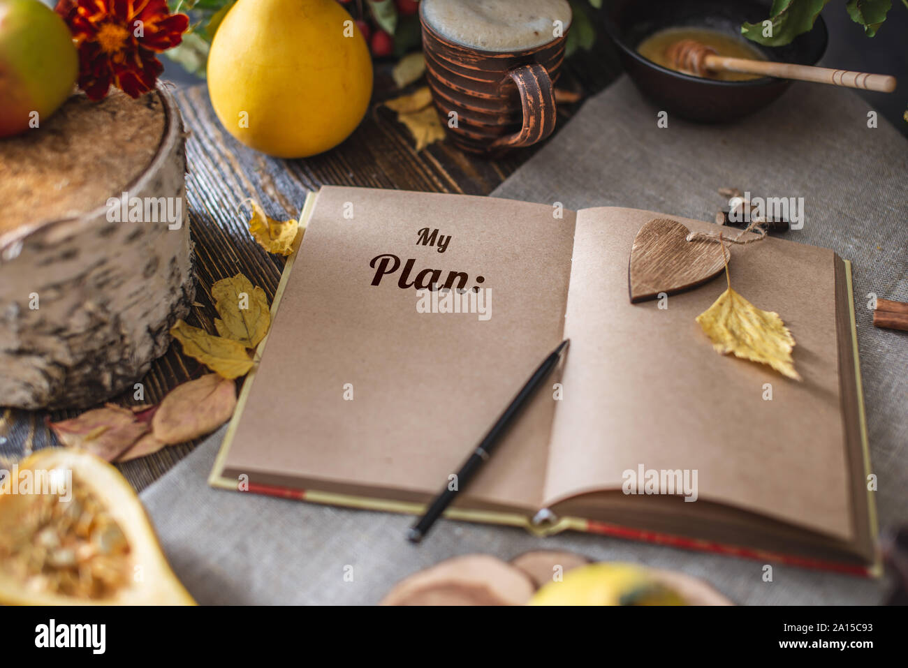 Autumn set of yellow leaves and flowers. Notebook with open pages on the table. Space for text. Top view. Concept my plan Stock Photo