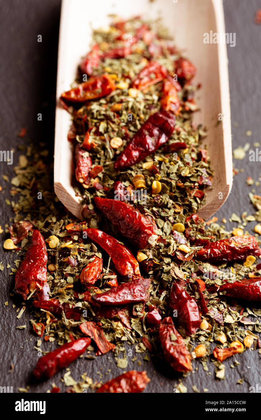Dried oregano and chillies on wooden scoop Stock Photo