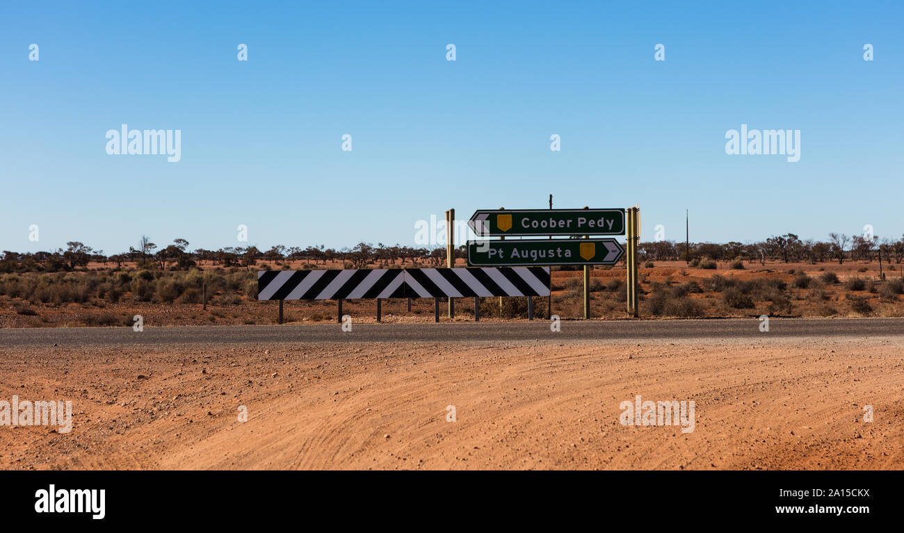 Exiting a dirt track its now decision time to head in two very different directions. North to Coober Pedy or South to Port Augusta on the Stuart Hwy. Stock Photo