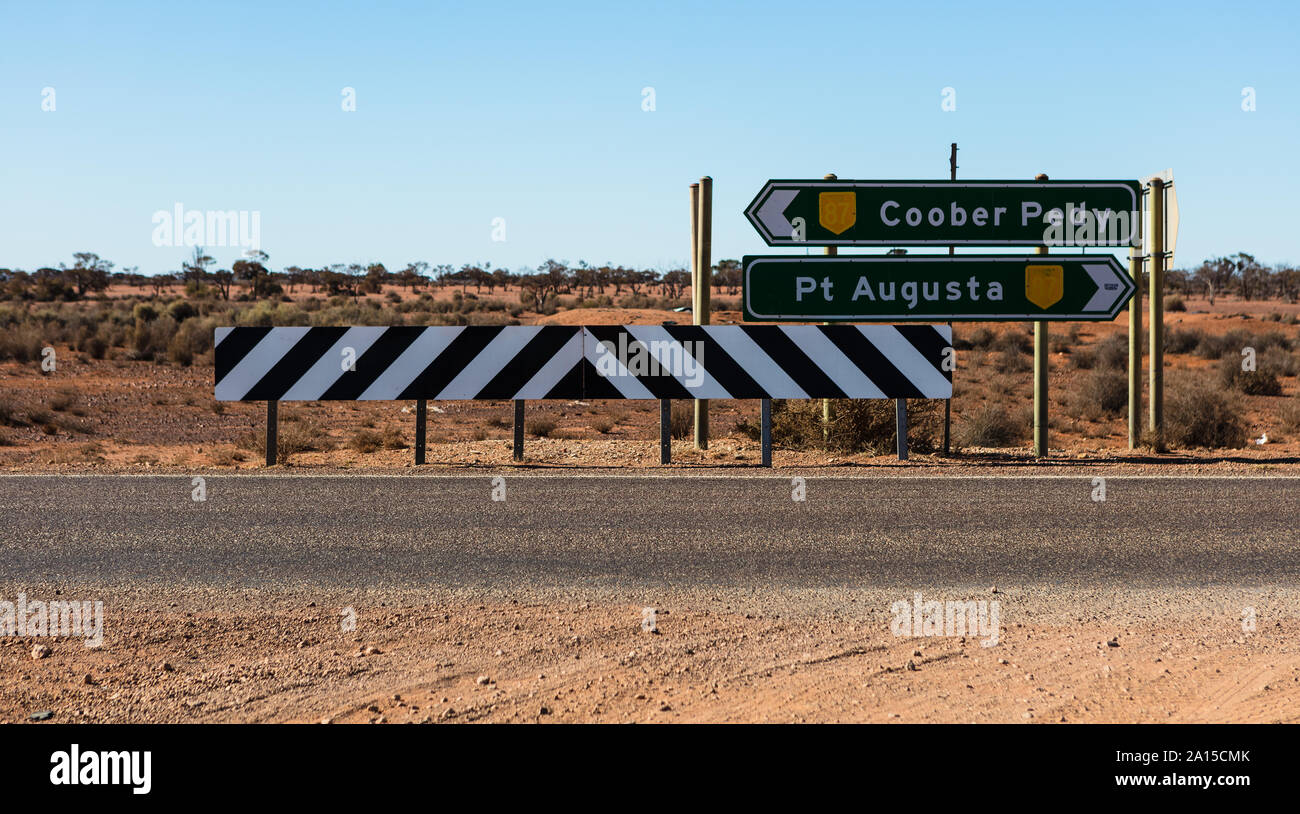 Exiting a dirt track its now decision time to head in two very different directions. North to Coober Pedy or South to Port Augusta on the Stuart Hwy. Stock Photo