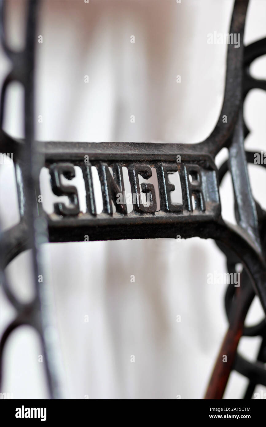 Kyiv, Ukraine - April 17, 2017: Close up of a metal Singer logo on an old american vintage manual sewing machine. Illustrative editorial Stock Photo