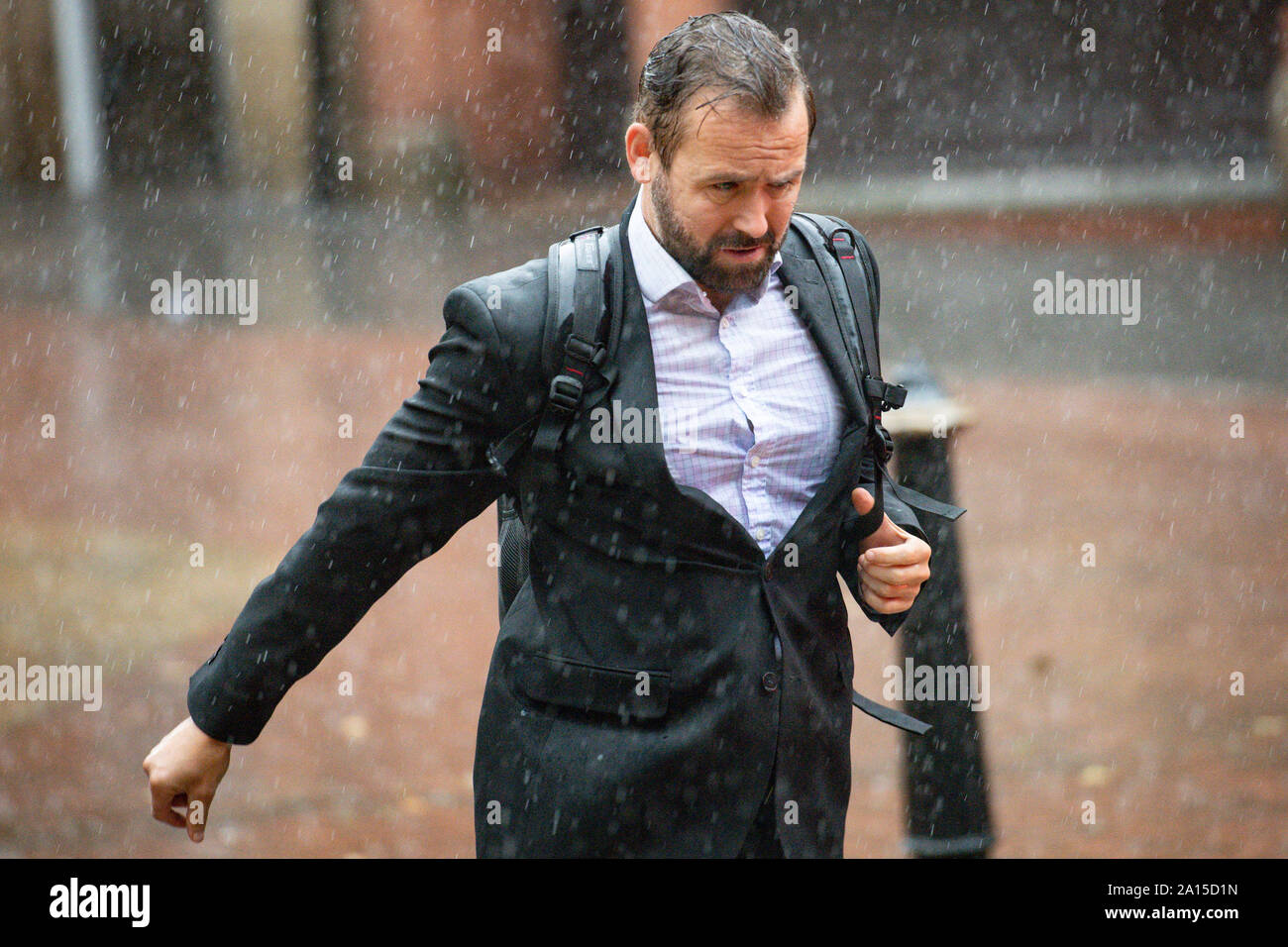 A man runs through heavy rain in Birmingham city centre. The Met Office ...