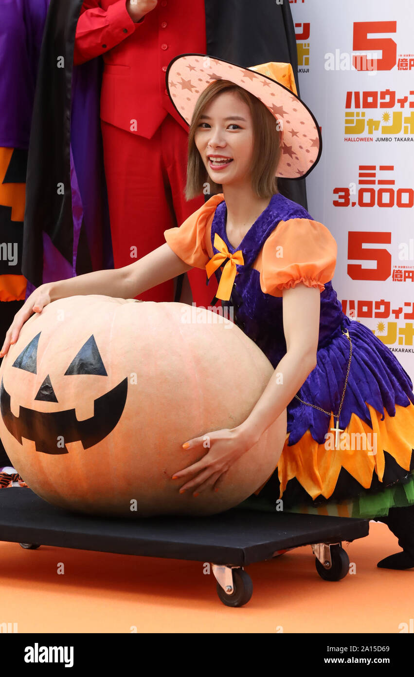 Tokyo, Japan. 24th Sep, 2019. Japanese TV personality Nao Asahi in costume  tries to carry a jack-o-lantern as she attends a promotional event of the  500 million yen Halloween Jumbo Lottery as